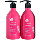 Two bright pink Luseta Keratin hair care bottles on a white surface with a blurred metal rack and light background behind them. The left bottle is Keratin Shampoo and the right bottle is Keratin Conditioner, both with black pump dispensers.