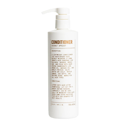 A white pump bottle of Coconut Apricot Conditioner by dda cosmetics, featuring a minimalist design with brown text on the front label.