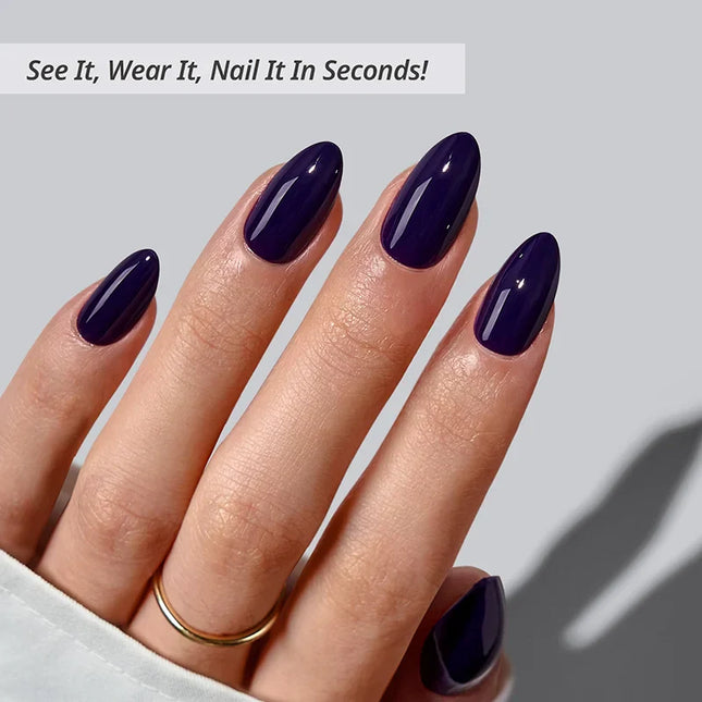 Detailed close-up of BTArtboxnails Storm Black soft gel nails in a high-shine glossy black finish, highlighting the elegant medium almond shape and natural apex.