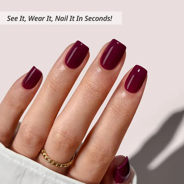 Close-up of BTArtboxnails Blackberry soft gel tips in a deep plum glossy finish, showing the natural nail apex and square shape.