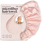 Pink satin hair towel with packaging displaying brand name and product details on a white background